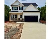 New two-story home with a black garage door, black shutters and a stone porch with natural wood posts at 60 Moonraker Dr, Spring Hope, NC 27882