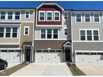 Charming townhouse exteriors featuring a mix of brick, siding, and stylish architectural details at 10014 Secluded Garden Drive Rd # 185, Apex, NC 27523