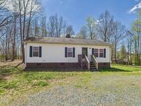 Charming one-story home with white siding, black shutters, and a small front porch at 109 Sweet Gum Hunting Club Rd, Mebane, NC 27302