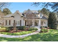 Charming two-story home boasts a manicured lawn and inviting front porch with detailed trim work at 1321 Colonial Club Rd, Wake Forest, NC 27587