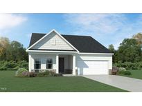Charming single-story home with stone accents, attached garage and manicured lawn at 1502 Red Roses Ave, Durham, NC 27703