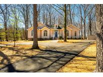 Charming single-story home boasts a long driveway and mature trees surrounding the property at 195 Shannon Ct Ct, Timberlake, NC 27583