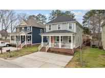 Charming two-story home with a welcoming front porch and well-maintained landscaping at 215 Seventh St, Wake Forest, NC 27587