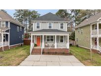Charming two-story home with a inviting front porch and freshly painted exterior at 215 Seventh St, Wake Forest, NC 27587