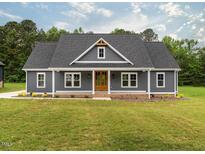 Charming single-story home with gray siding, a welcoming front porch, and a well-maintained lawn at 4037 Mebane Oaks Rd, Mebane, NC 27302