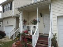 Charming front porch with stairs, railings, and flowers for a welcoming curb appeal at 4245 Toccopola St, Raleigh, NC 27604