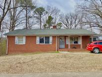 Charming single-story brick home with traditional shutters and a well-maintained lawn at 4308 Old Chapel Hill Rd Rd, Durham, NC 27707