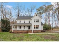 Charming two-story home with a welcoming front porch and well-manicured lawn at 5044 Allanbrooke Ln, Fuquay Varina, NC 27526