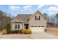 Charming two-story home with light siding, well-kept landscaping, and attached two car garage at 580 Long View Dr, Youngsville, NC 27596