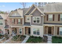 Charming townhome with stone accents, neutral siding, and well-maintained landscaping at 6233 Pesta Ct, Raleigh, NC 27612