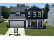 Charming two-story home with a two-car garage and well-manicured lawn at 704 Compeer Way # 28, Rolesville, NC 27571