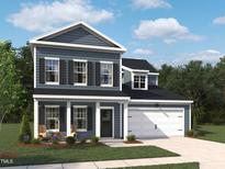 Charming two-story home with a covered front porch, attached garage, and manicured lawn in a desirable neighborhood at 704 Compeer Way # 28, Rolesville, NC 27571