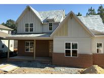 New construction home featuring a brick and siding exterior with modern architectural details at 829 Chapel Ridge Dr, Pittsboro, NC 27312