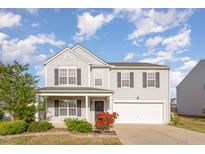 Charming two-story home with a well-manicured lawn and attached two-car garage at 1009 Limeberry Ct, Clayton, NC 27520