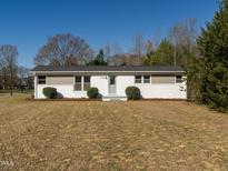 Charming single-story home featuring a classic design and inviting curb appeal at 1018 Roxboro St, Haw River, NC 27258