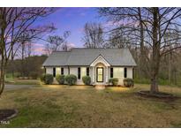 Charming home featuring manicured bushes, black shutters, and well-maintained lawn at 102 Steven Pl, Benson, NC 27504