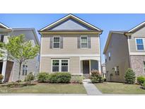 Charming two-story home with a well-manicured lawn, inviting entryway, and beautiful landscaping at 109 Belle Plain Dr, Morrisville, NC 27560