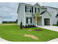 Charming two-story home with attached garage, manicured lawn, and classic black shutters and siding at 111 Shore, Clayton, NC 27577