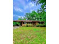 Charming single-story brick home with a carport and well-maintained lawn at 1115 Park Ave, Henderson, NC 27536