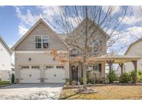Charming two-story home featuring an attached two-car garage and manicured landscaping at 1207 Colton Creek Rd, Knightdale, NC 27545
