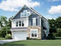 Charming two-story home boasts a modern design with stone accents and a well-manicured lawn at 1404 Sparkling Lake Dr # 71, Apex, NC 27523