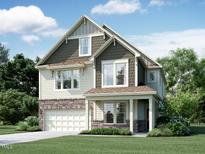 Charming two-story home with a combination of stone and siding and a well-manicured front lawn at 1424 Sparkling Lake Dr # 66, Apex, NC 27523