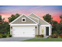 Two-story home with neutral siding, two car garage, landscaped yard and beautiful sunset at 2340 Beeblossom Pl, Fuquay Varina, NC 27526