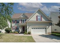 Charming two-story home featuring a two-car garage and well-maintained landscaping at 400 Leacroft Way, Morrisville, NC 27560