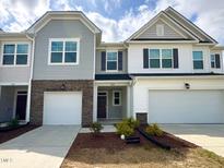 Charming townhome with well-maintained lawn, attached garages, and craftsman-style architecture at 5014 Kota St, Raleigh, NC 27610