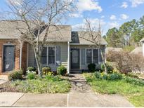 Charming home featuring a well-manicured front yard with lush landscaping and inviting walkway at 60 Justin Ct, Durham, NC 27705