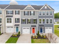 Charming townhomes with colorful doors, one-car garages, and manicured lawns at 609 Silverado Sunset Loop, Wendell, NC 27591