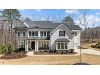 Beautiful two-story home with stone and white shingle siding, black shutters, and a well-manicured lawn at 7100 Hasentree Club Dr, Wake Forest, NC 27587