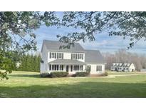 Charming two-story home boasts a welcoming porch and well-manicured lawn surrounded by mature trees at 723 Whitt Town Rd Rd, Roxboro, NC 27574