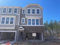 New townhome build with a brick and grey facade, two stories, and attached two car garage at 1200 Alston Landing Way # 05, Cary, NC 27519