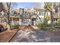 Charming townhome featuring a well-kept front yard and classic architectural details at 1303 Dylan Heath Ct, Raleigh, NC 27608