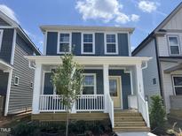 Charming two-story home featuring a welcoming front porch and a bright yellow front door at 1919 Plott Balsam Dr, Wendell, NC 27591