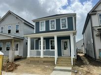 Charming two-story home featuring a covered front porch with classic white columns at 1919 Plott Balsam Dr, Wendell, NC 27591