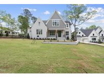 Stunning two-story home featuring painted brick, gray accents, manicured lawn, and welcoming entrance at 2829 Theresa Eileen Way, Raleigh, NC 27603
