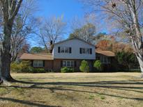 Charming two-story home featuring a brick facade and a well-maintained front yard at 3601 Colonial Ln, Rocky Mount, NC 27804