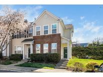 Charming townhome with brick accents, green door, and blossoming tree at 3615 Ramblewood Ave, Durham, NC 27713