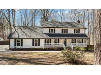 Charming two-story home featuring a welcoming front porch and classic black shutters at 403 Mill Creek Dr, Fuquay Varina, NC 27526