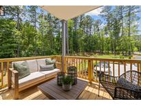 Outdoor patio with comfortable seating, stylish decor, and a view of the surrounding landscape at 4706 Cypress Tree Ln, Raleigh, NC 27612