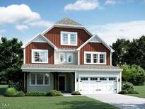 Charming two-story home with a two-car garage, welcoming entrance, and manicured lawn at 5026 Aged Pine Rd # 48, Apex, NC 27523