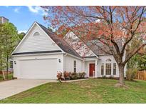 Charming one-story home with white siding, a well-manicured lawn, and a lovely red front door at 5814 Solitude Way, Durham, NC 27713