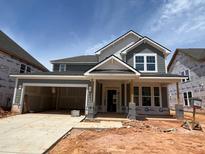 New construction, two-story home with a two-car garage and inviting front porch at 789 Old Station Pointe, Angier, NC 27501