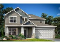 Charming two-story home featuring gray siding, stone accents, and a well-manicured lawn on a sunny day at 789 Olde Station Pointe, Angier, NC 27501