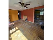 Spacious living room features hardwood floors and a ceiling fan at 1109 Magnolia Dr, Durham, NC 27707