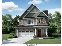 Charming two-story home showcasing a spacious two-car garage and covered entry with landscaped front yard at 1382 Sparkling Lake Dr # 75, Apex, NC 27523