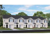 Attractive townhome exterior showcasing a symmetrical design, individual garages, and well-manicured landscaping at 152 Holton St, Smithfield, NC 27577