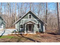 Charming craftsman home with green siding, white trim, and inviting front porch at 211 Fleming Dr, Durham, NC 27712